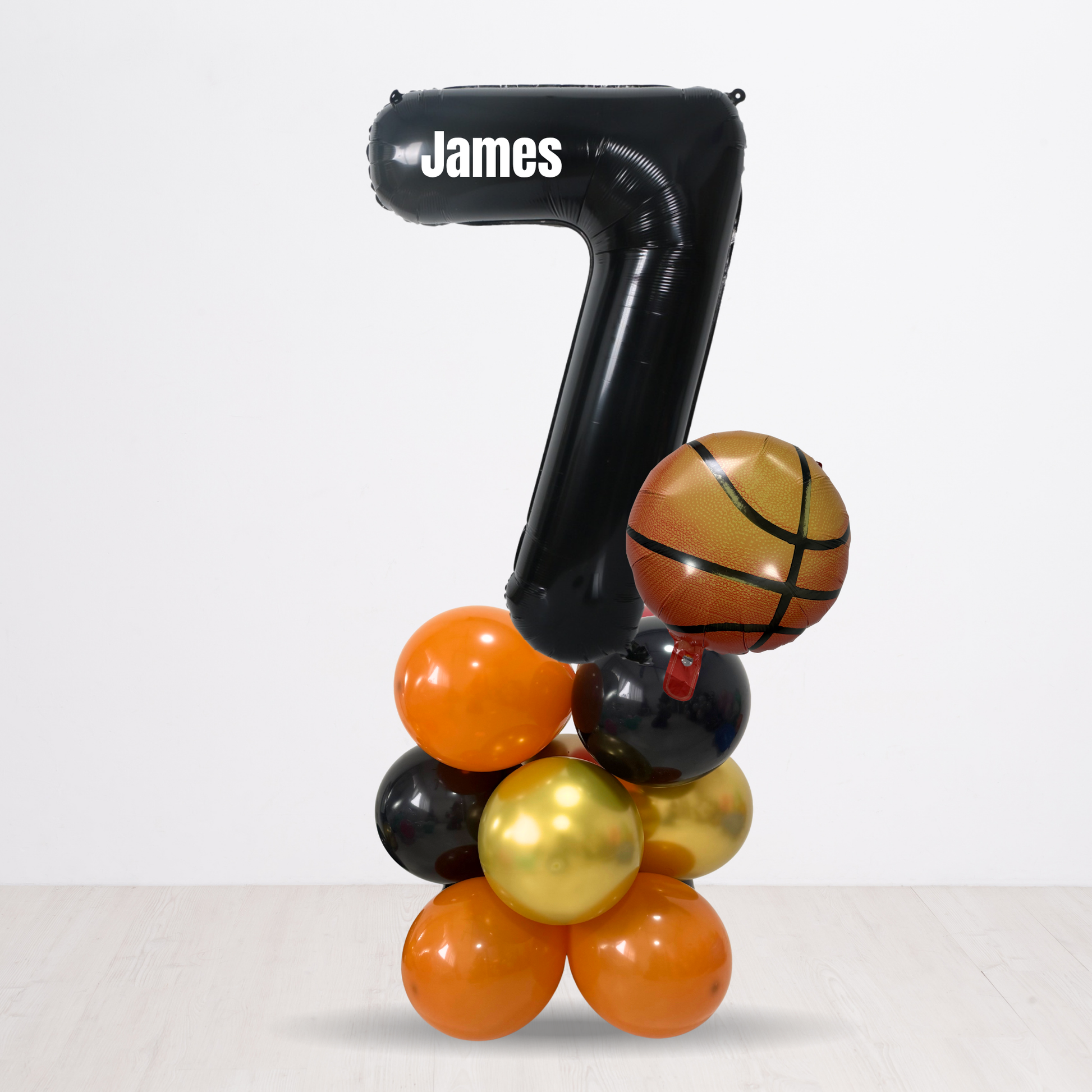 Black balloon with 'James' and number '7', surrounded by colorful balloons on a white background