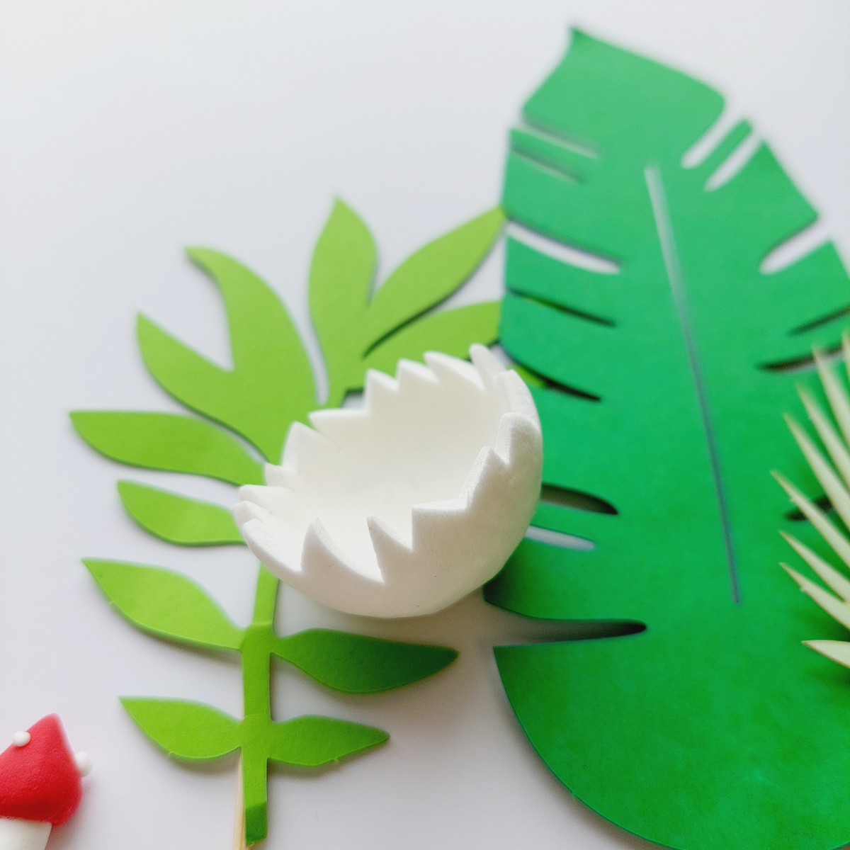 Clay Dinosaurs leaves mushroom egg shells Cake Topper set lifestyle photo