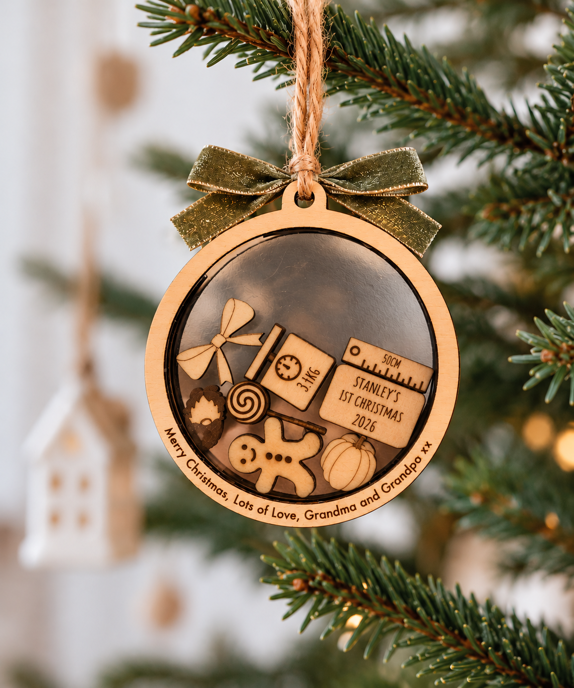 Personalised first Christmas wooden circle shaker bauble hanging on Christmas tree with engraved rim message