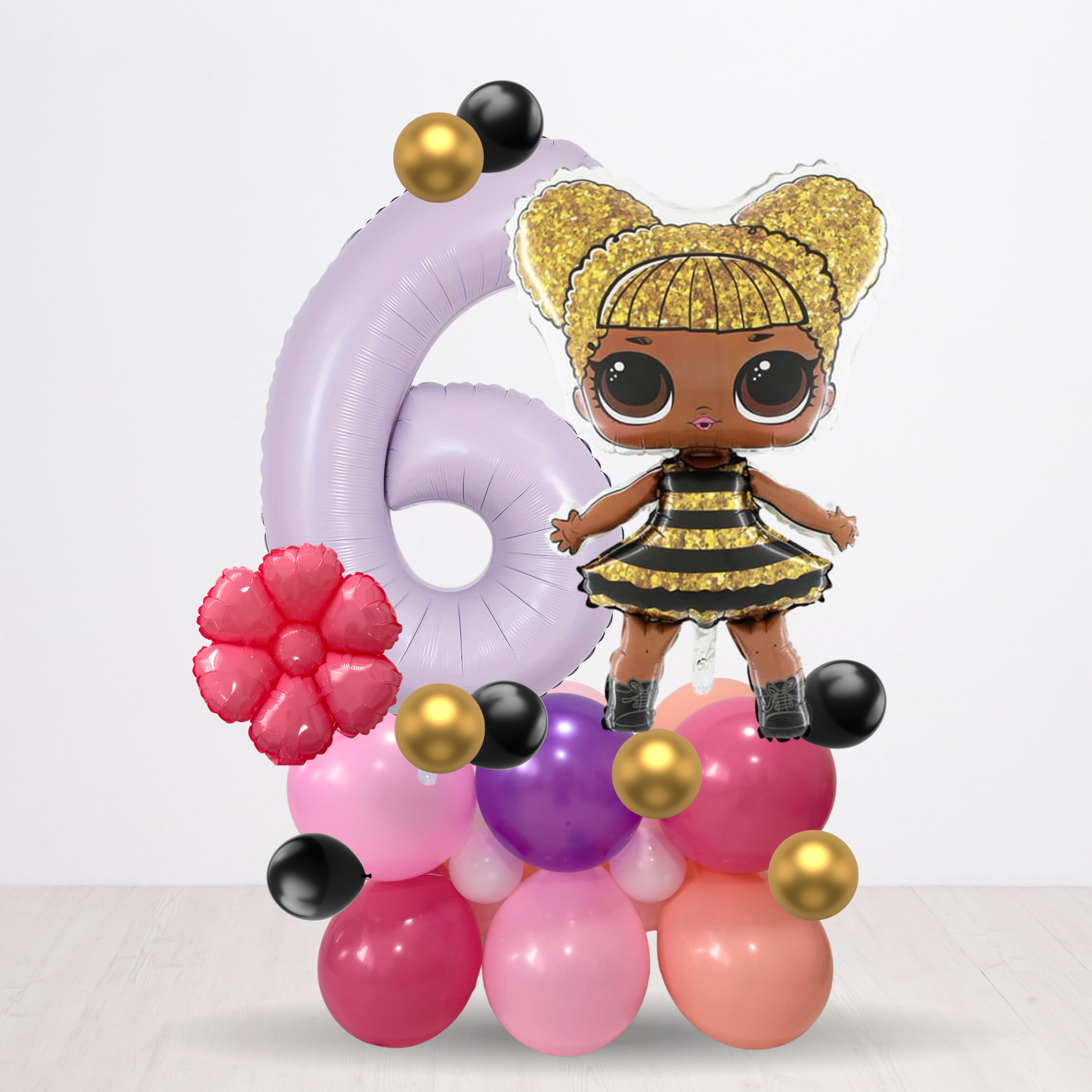 Decorative number '6' made of balloons with a doll in a bee costume on a white background