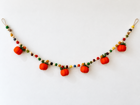 Handcrafted felt pumpkin garland with six orange pumpkins and wooden beads